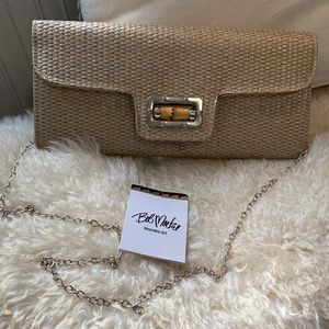 Vintage BOB MACKIE wearable art. It’s a woven gold rattan clutch with chain!
